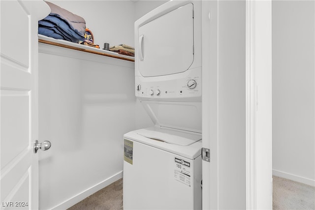 laundry room with stacked washer and dryer and light colored carpet