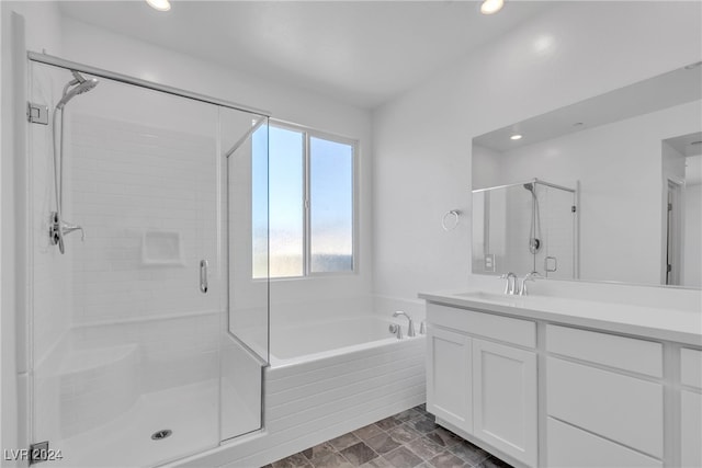 bathroom featuring vanity and plus walk in shower