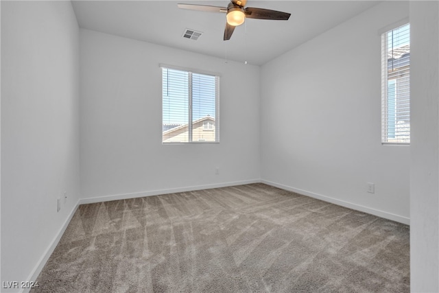 spare room with light carpet and ceiling fan