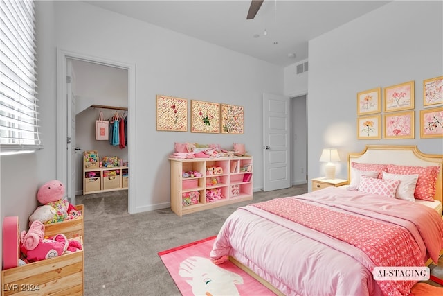 carpeted bedroom featuring ceiling fan and a closet