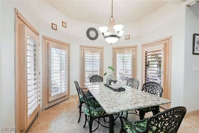 dining space featuring light tile patterned floors and a chandelier