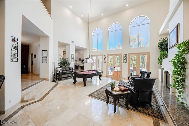 recreation room with pool table, marble finish floor, french doors, a fireplace, and recessed lighting