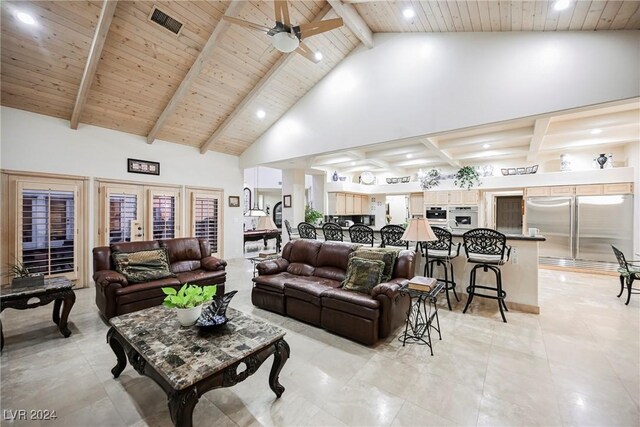 tiled living room featuring ceiling fan, high vaulted ceiling, and beam ceiling