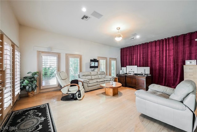 living room with wood finished floors and visible vents