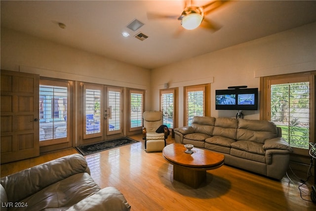 living room with ceiling fan, hardwood / wood-style floors, and french doors