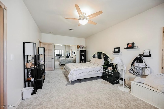 bedroom with carpet floors, a closet, visible vents, and a ceiling fan