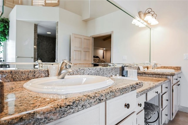 bathroom featuring a sink and double vanity