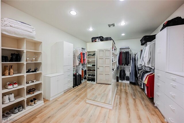 walk in closet with light wood-type flooring