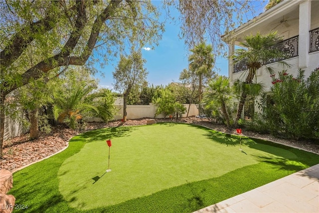 view of yard featuring a fenced backyard and a ceiling fan