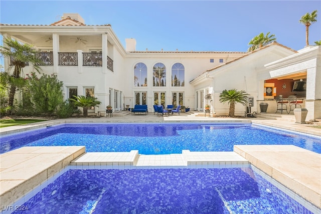 view of pool with ceiling fan and a patio