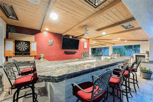 bar with wooden ceiling, beam ceiling, ceiling fan, and tile patterned flooring