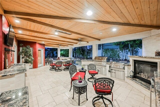 view of patio / terrace with ceiling fan, an outdoor kitchen, and area for grilling