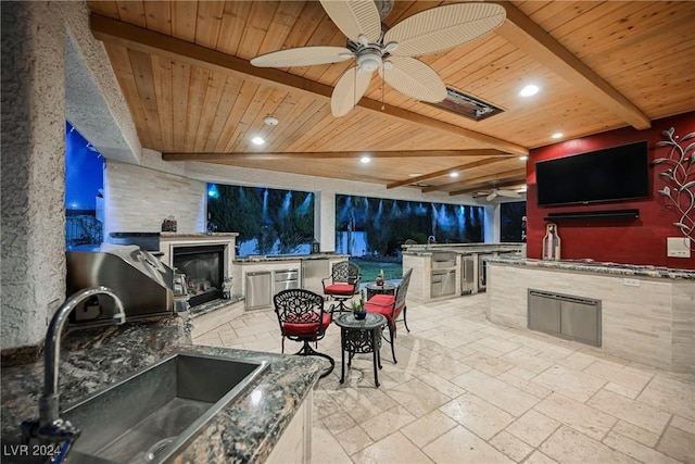 view of patio / terrace with area for grilling, an outdoor kitchen, a sink, and a ceiling fan