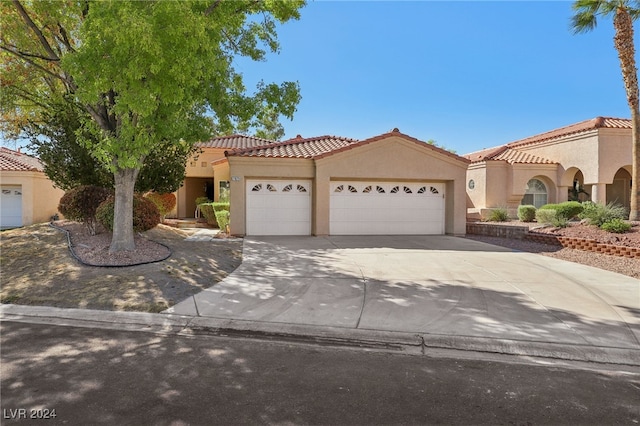 mediterranean / spanish house featuring a garage