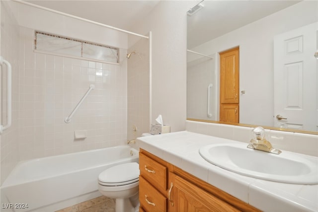 full bathroom featuring vanity, tiled shower / bath combo, toilet, and tile patterned flooring