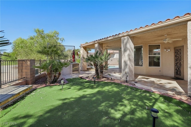 view of yard featuring ceiling fan and a patio area