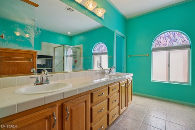 bathroom featuring walk in shower, a healthy amount of sunlight, tile patterned flooring, and vanity