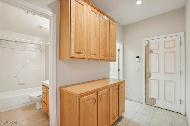 full bathroom featuring vanity, tile patterned flooring, tiled shower / bath, and toilet