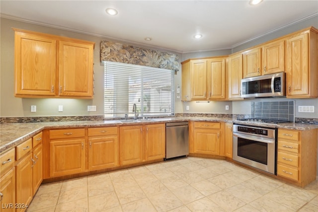 kitchen with stainless steel appliances, dark stone countertops, crown molding, and sink