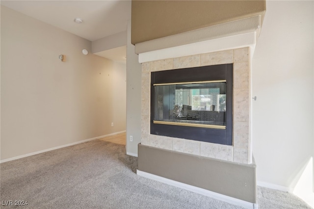 room details featuring carpet floors and a tiled fireplace