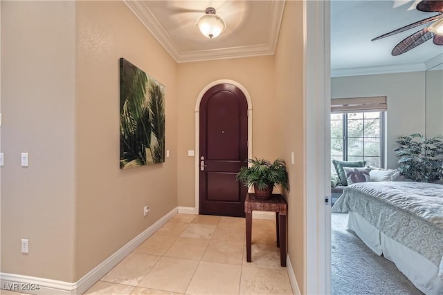 entrance foyer featuring light tile patterned flooring, crown molding, baseboards, and ceiling fan