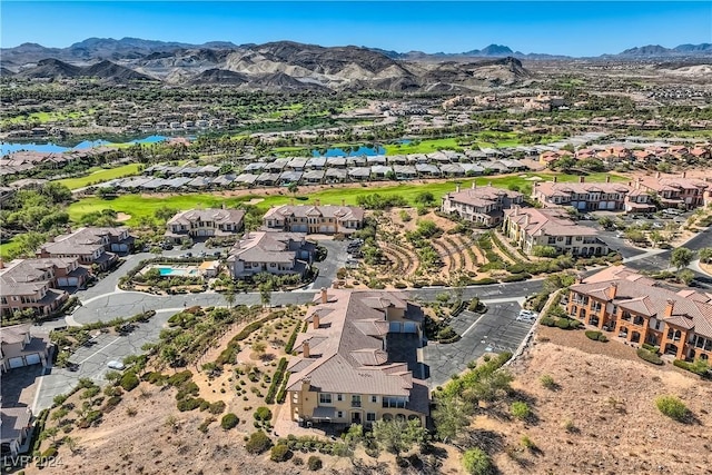 drone / aerial view with a residential view and a water and mountain view