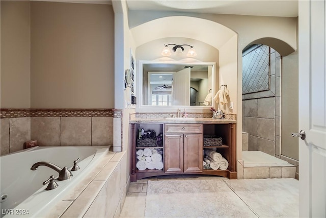 bathroom featuring vanity and a bath