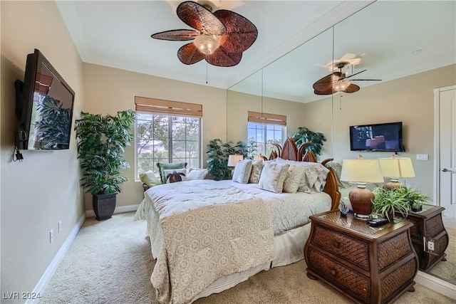 bedroom with baseboards, crown molding, carpet, and a ceiling fan