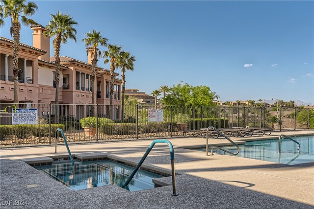 view of pool featuring a residential view, fence, and a patio area