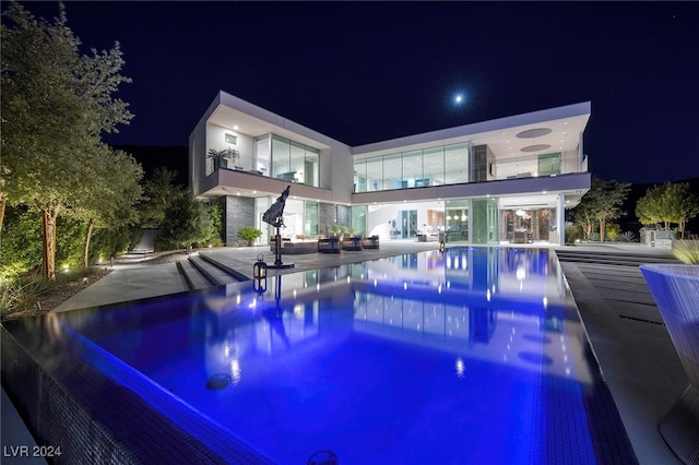 pool at twilight with a patio