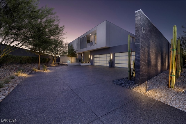 contemporary house featuring concrete driveway and stucco siding