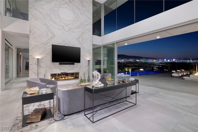 living room featuring a premium fireplace and a high ceiling