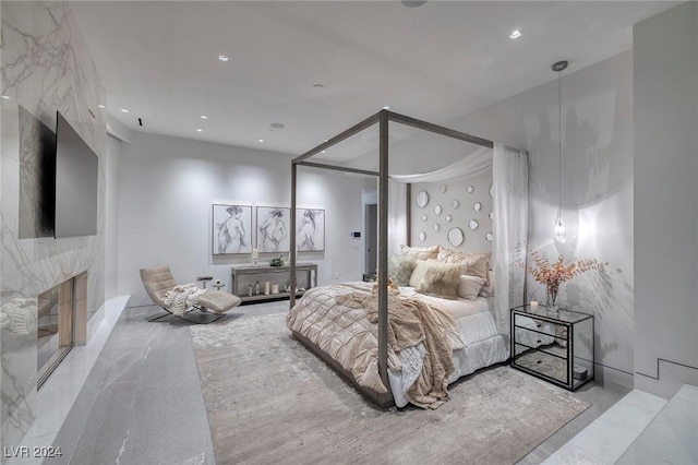 bedroom featuring a fireplace and recessed lighting