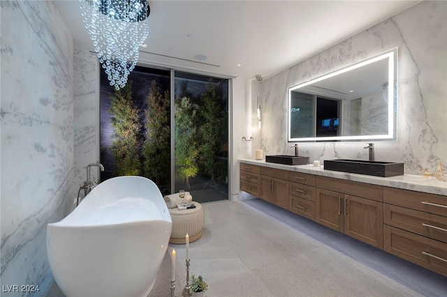 bathroom featuring vanity, an inviting chandelier, and a bath