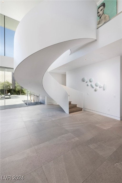 staircase featuring a towering ceiling