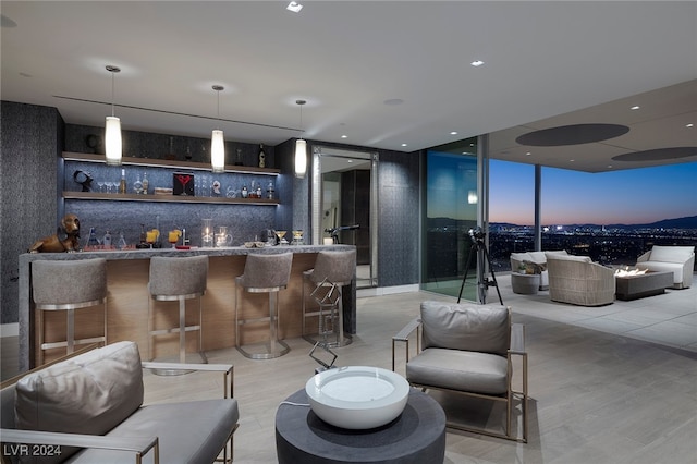 bar with light hardwood / wood-style floors, tasteful backsplash, decorative light fixtures, and floor to ceiling windows