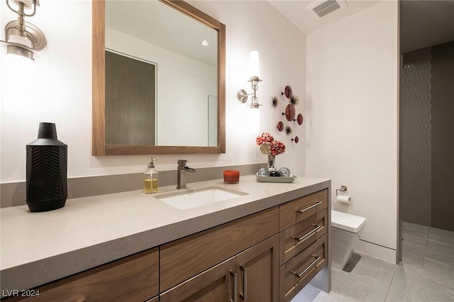 bathroom featuring visible vents, vanity, toilet, and tile patterned floors