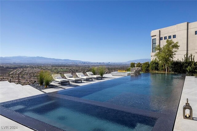 view of pool featuring a patio and a mountain view