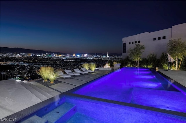 pool at night with an outdoor pool