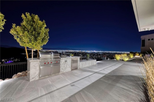 patio at night with grilling area and area for grilling