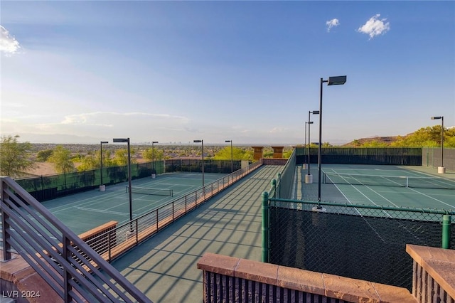 view of tennis court featuring fence