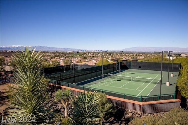 view of tennis court featuring a mountain view