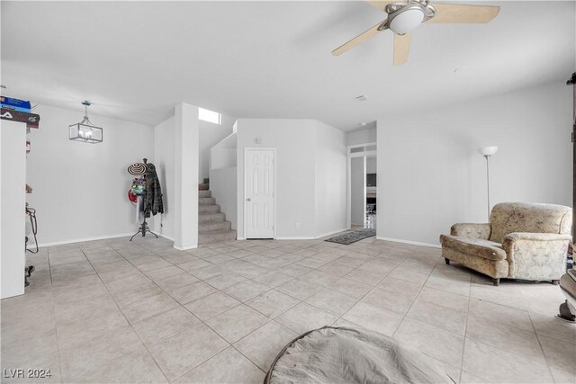 living room featuring light tile patterned flooring and ceiling fan