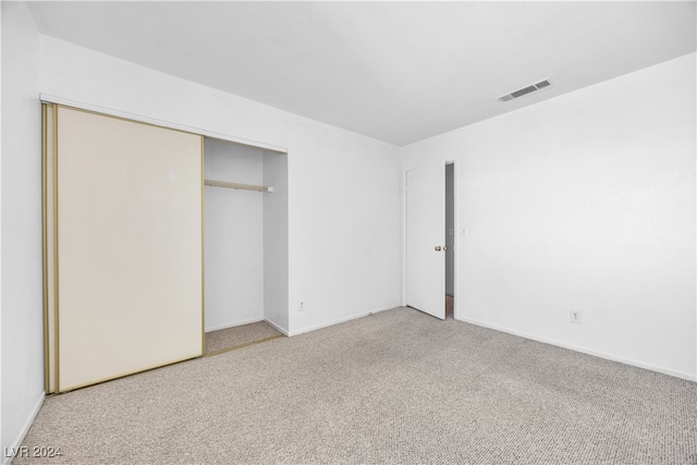 unfurnished bedroom featuring a closet and carpet