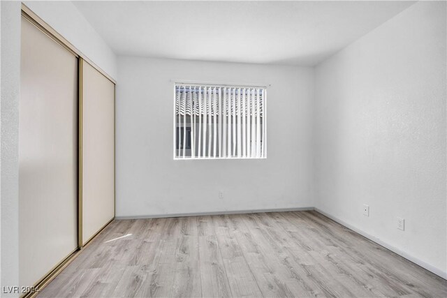 unfurnished room with light hardwood / wood-style floors