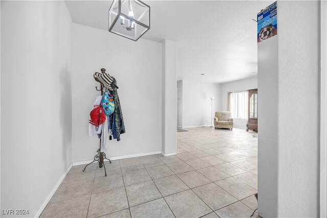 interior space featuring a chandelier and light tile patterned floors