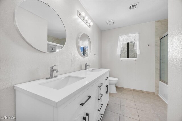 full bathroom featuring tile patterned floors, enclosed tub / shower combo, vanity, and toilet