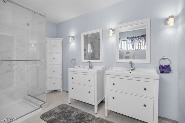 bathroom with walk in shower, wood-type flooring, and vanity