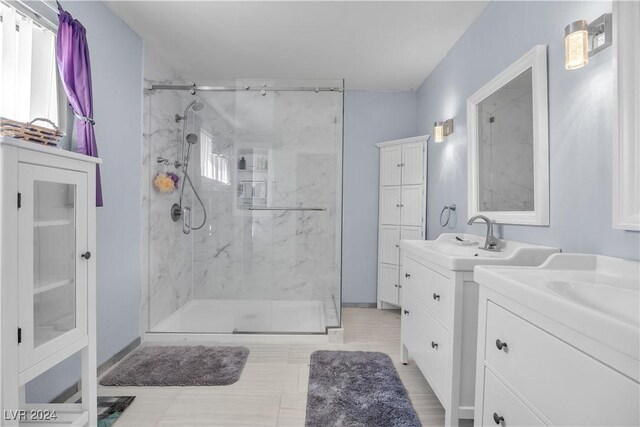 bathroom featuring vanity and a shower with shower door