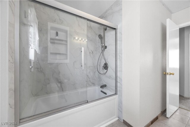 bathroom with enclosed tub / shower combo and tile patterned floors